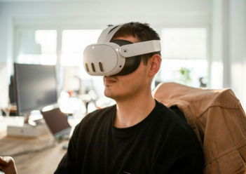 a man sitting in a chair wearing a pair of virtual glasses